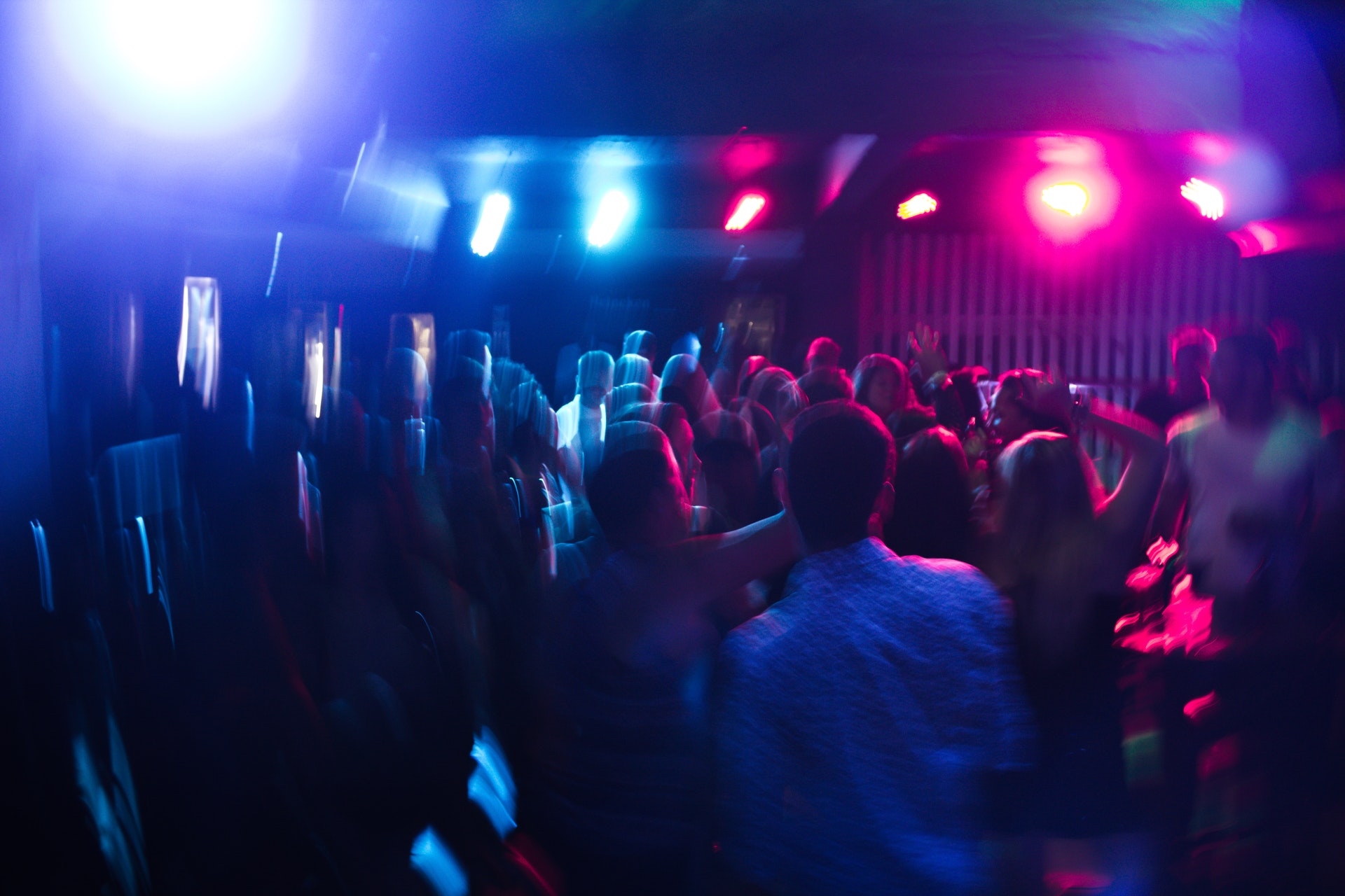 room of people dancing to music and lights