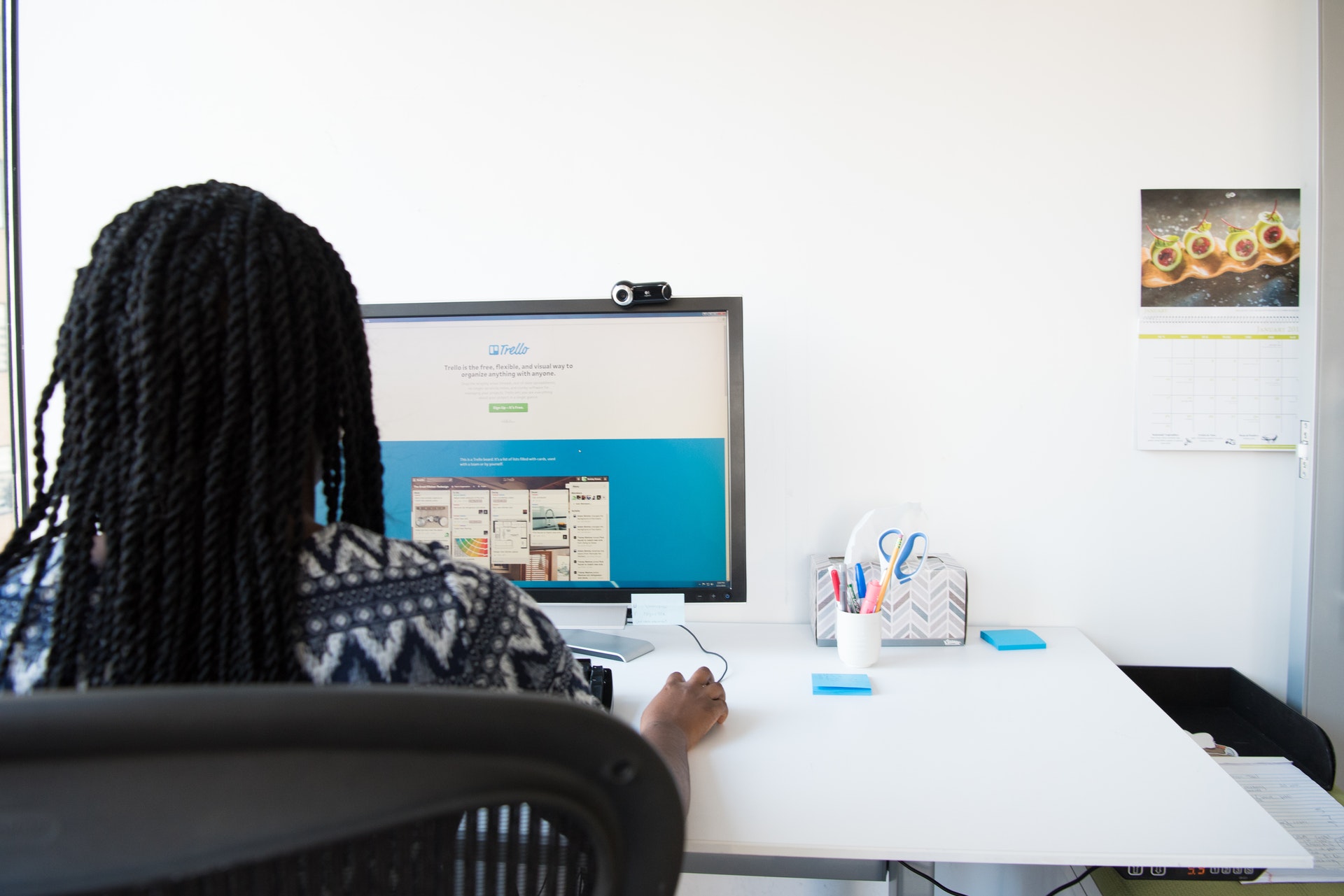 black woman sitting at a desk working on a computer