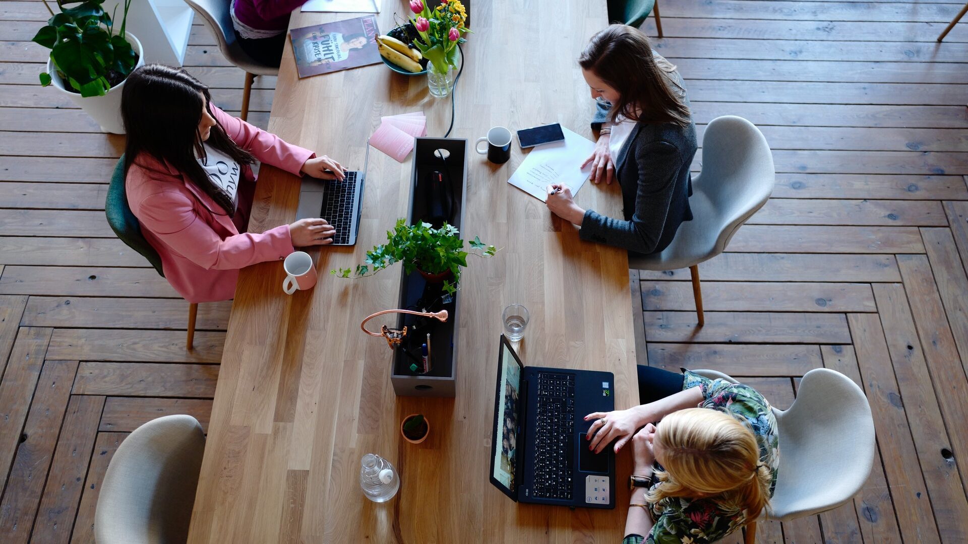 women working at a long table