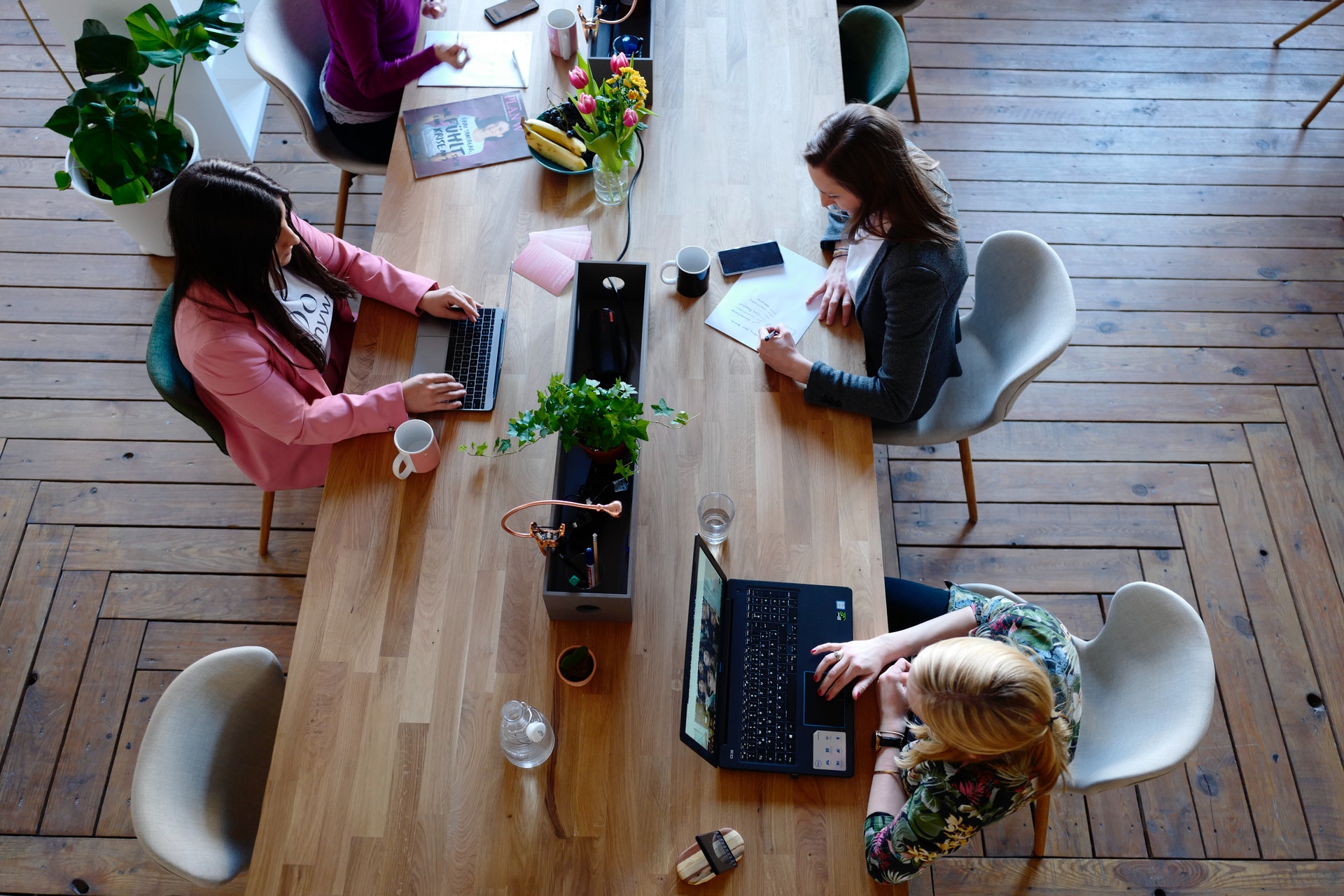 women working at a long table