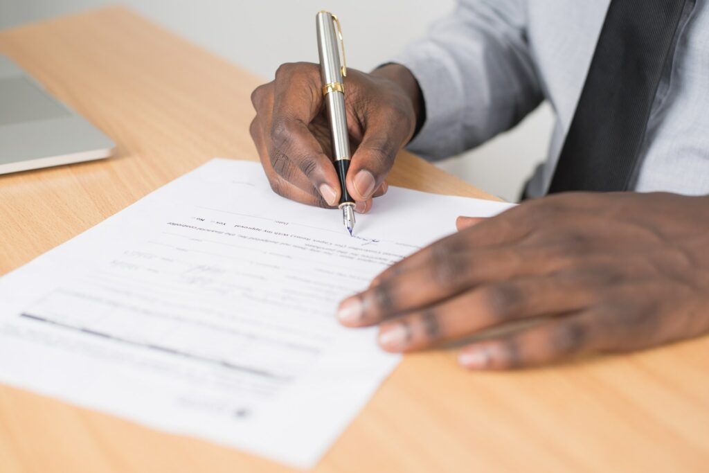 black man signing forms
