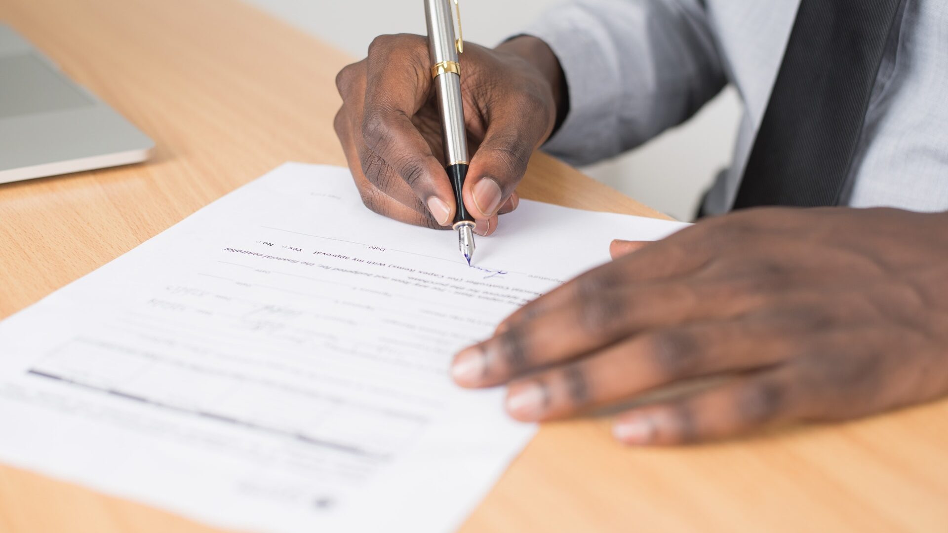 black man signing forms