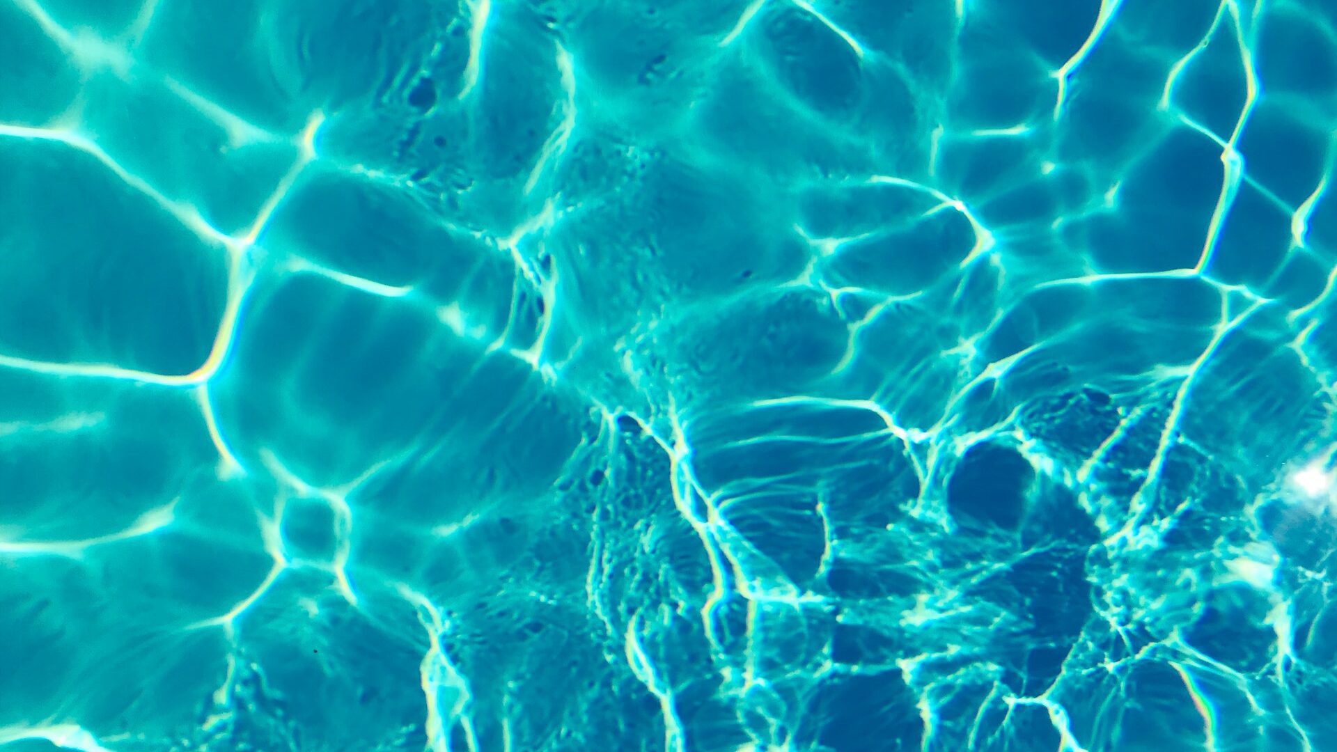 sun shining through water in a swimming pool