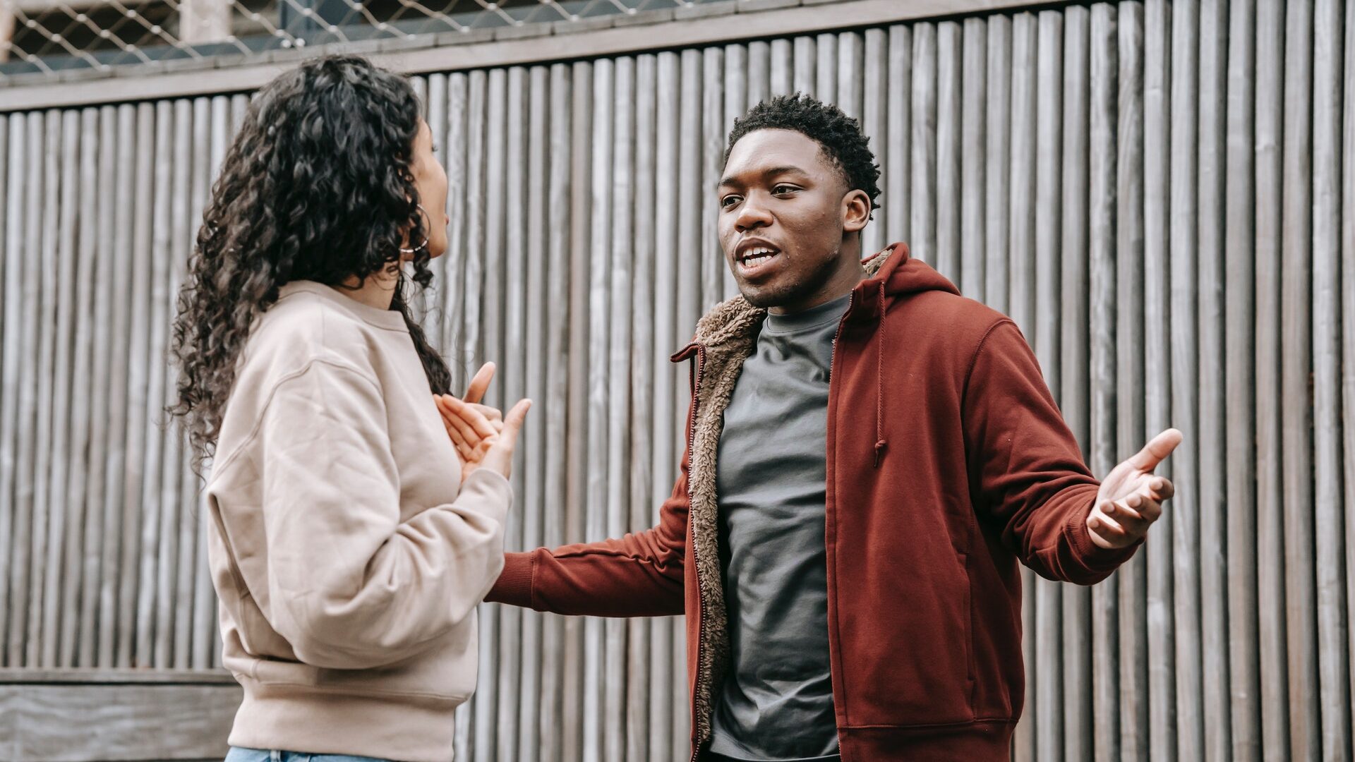 a black man and a latinx woman arguing