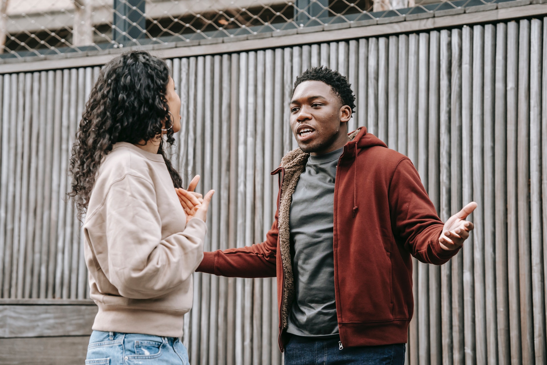 a black man and a latinx woman arguing