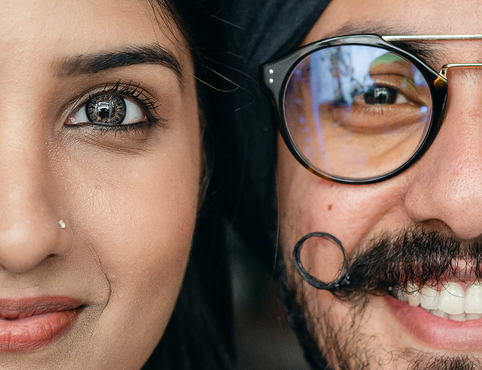 Happy young Indian couple looking at camera