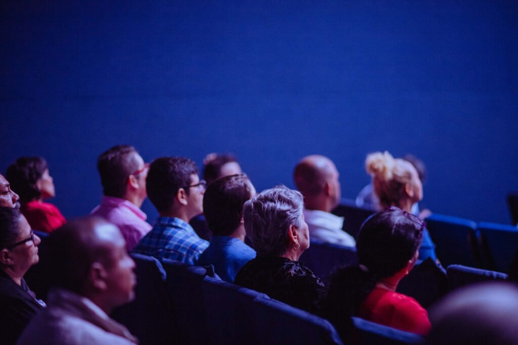People Sitting in Chairs in a movie theatre