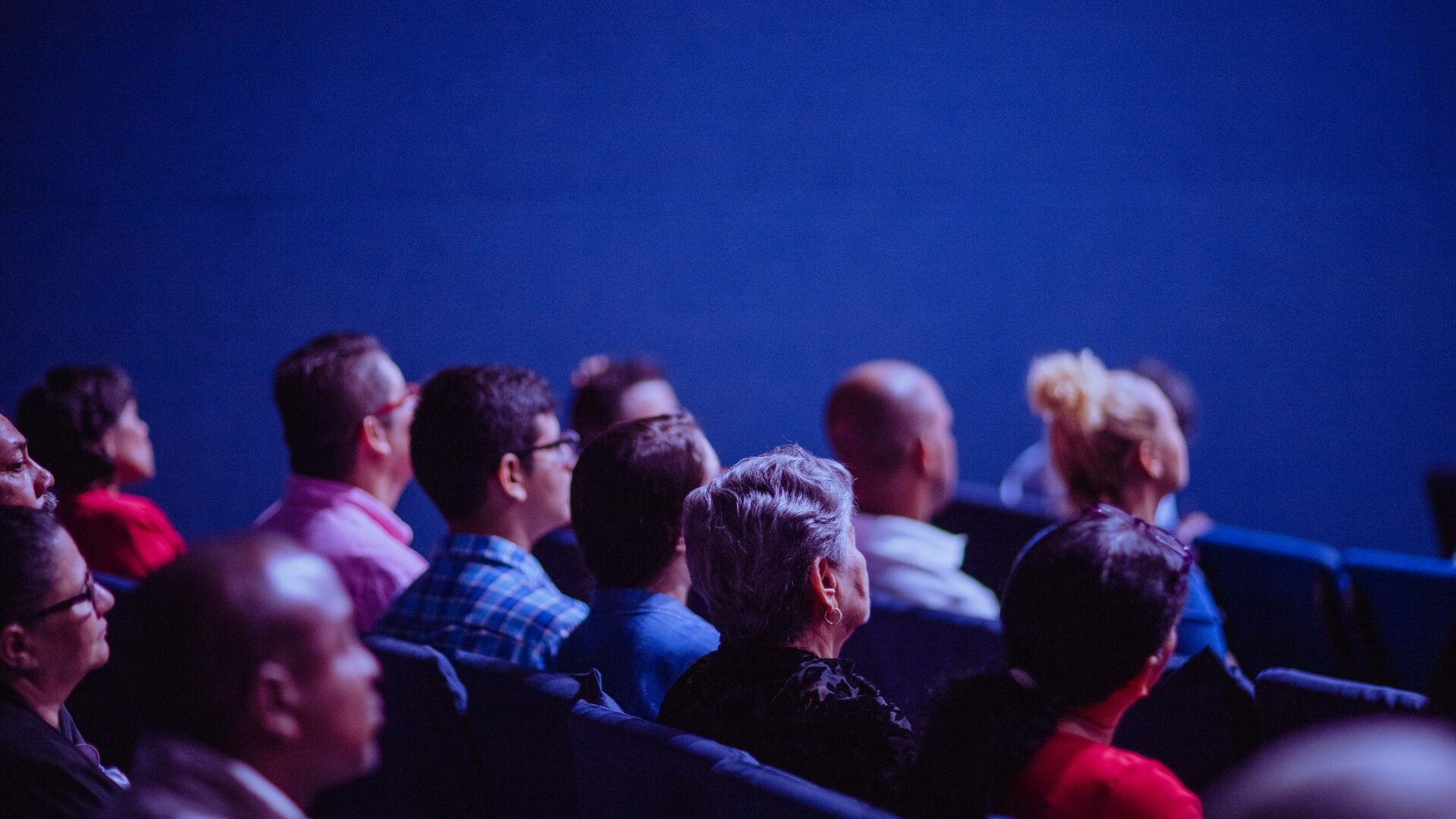 People Sitting in Chairs in a movie theatre