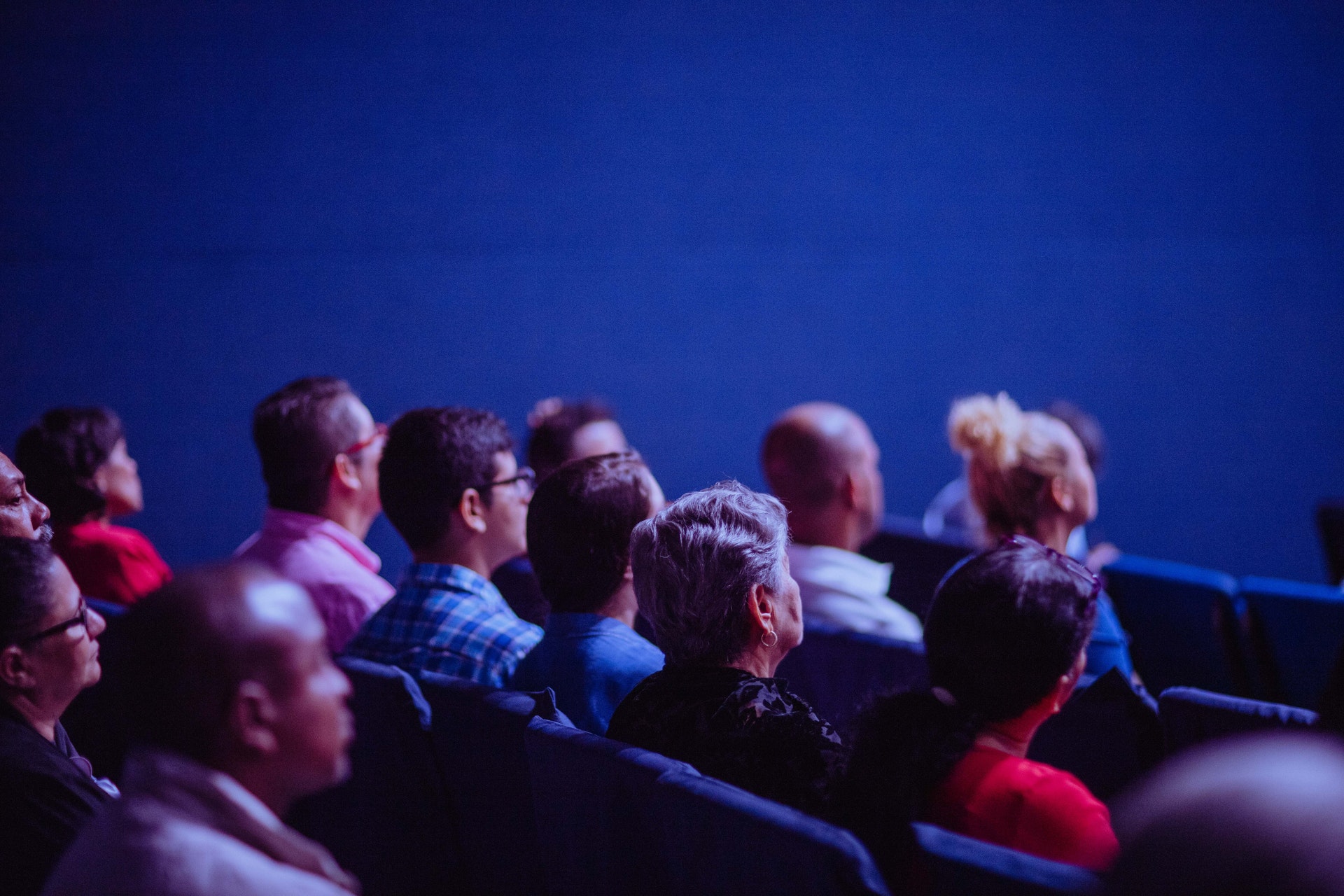 People Sitting in Chairs in a movie theatre