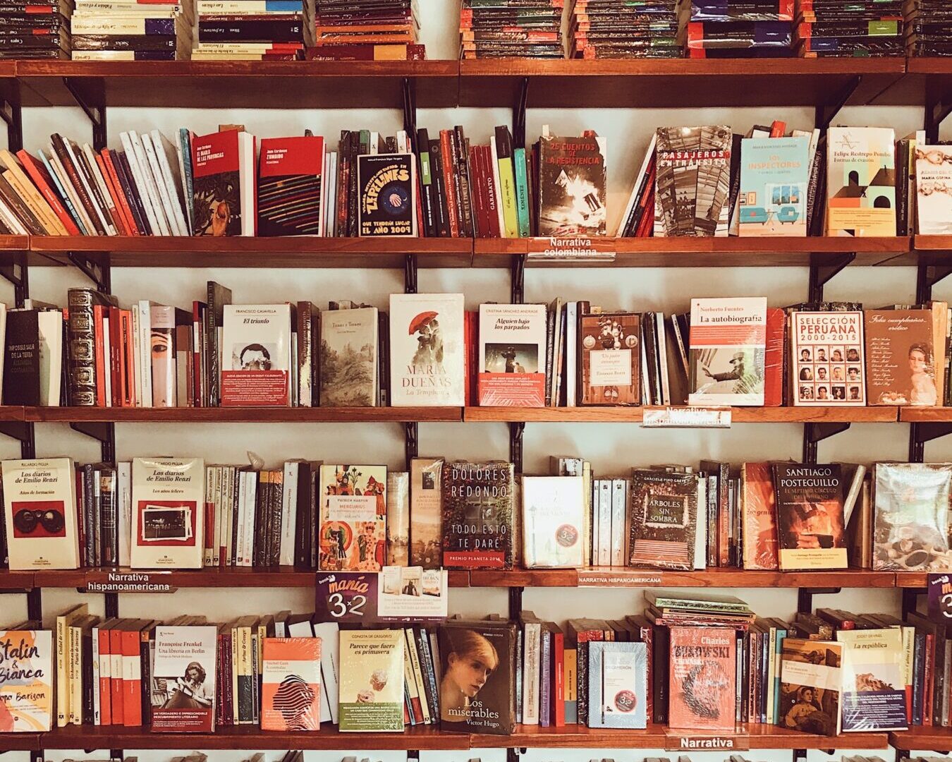 Assorted Title Books on Brown Wooden Shelf