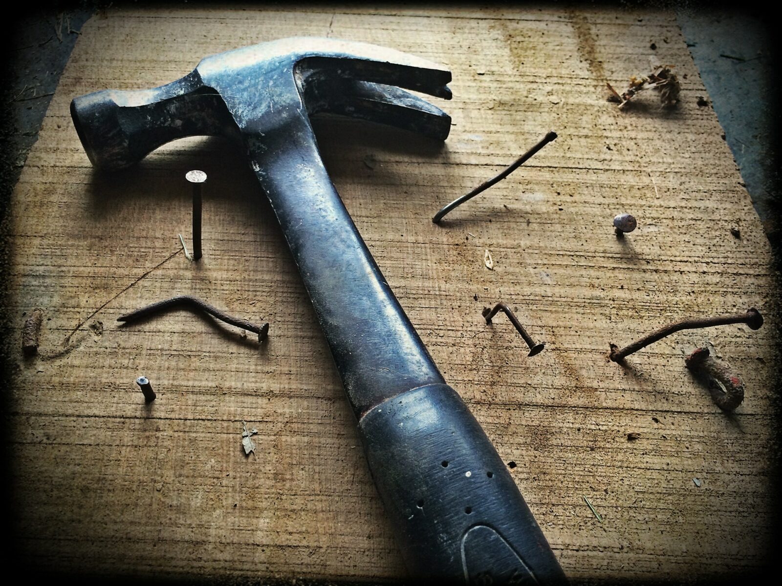 a hammer sitting on a table with nails