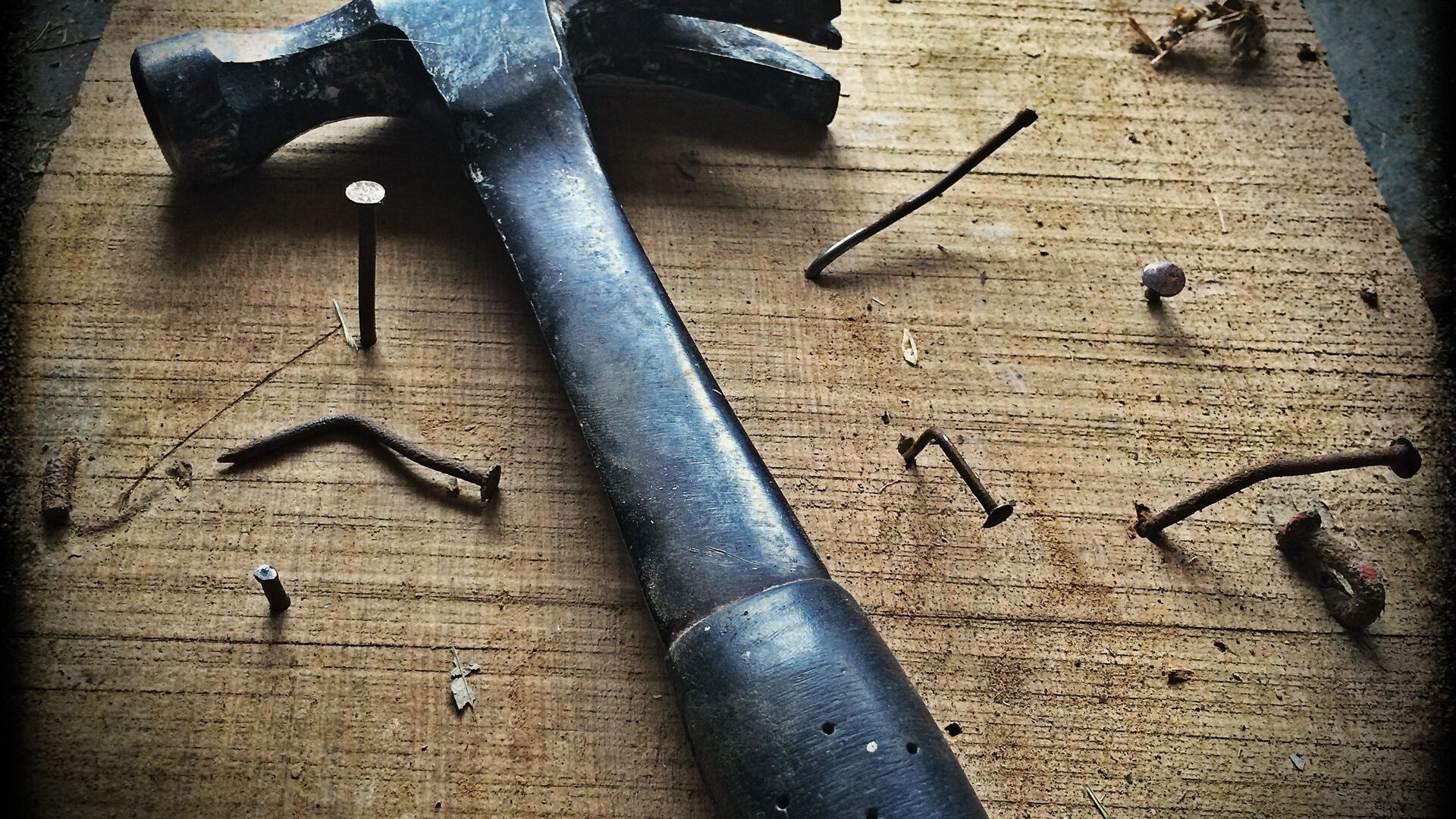 a hammer sitting on a table with nails