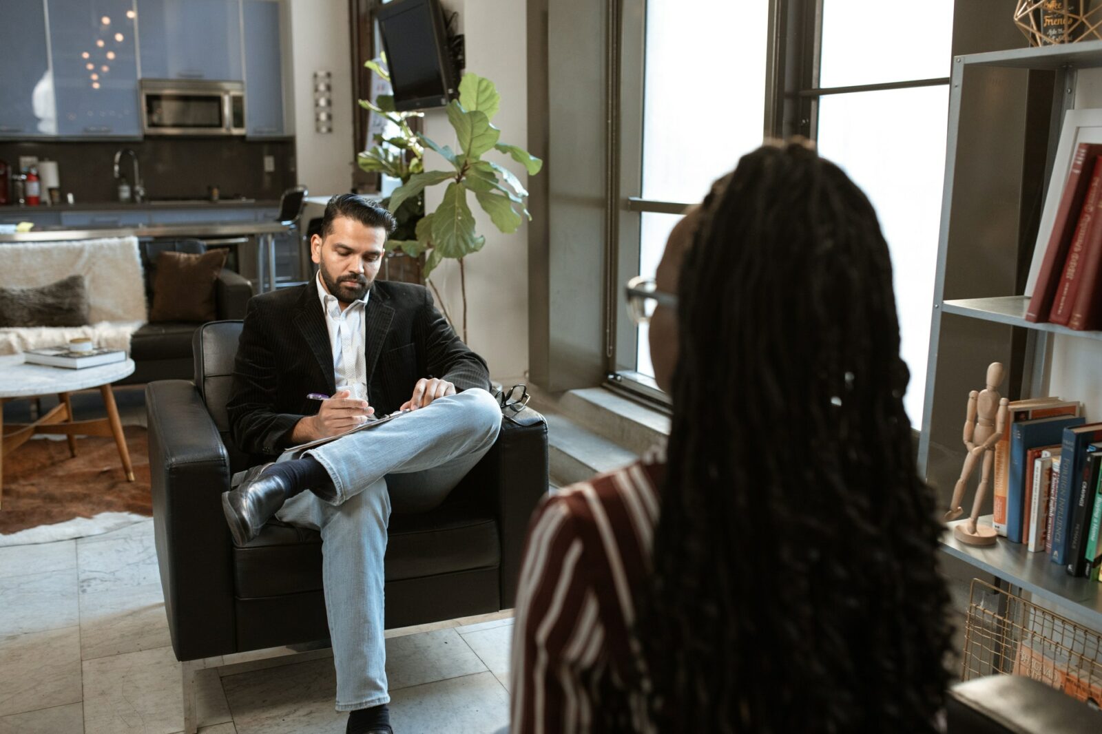 asian man interviewing a black woman