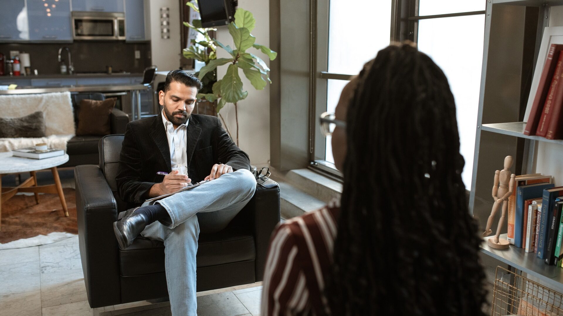 asian man interviewing a black woman