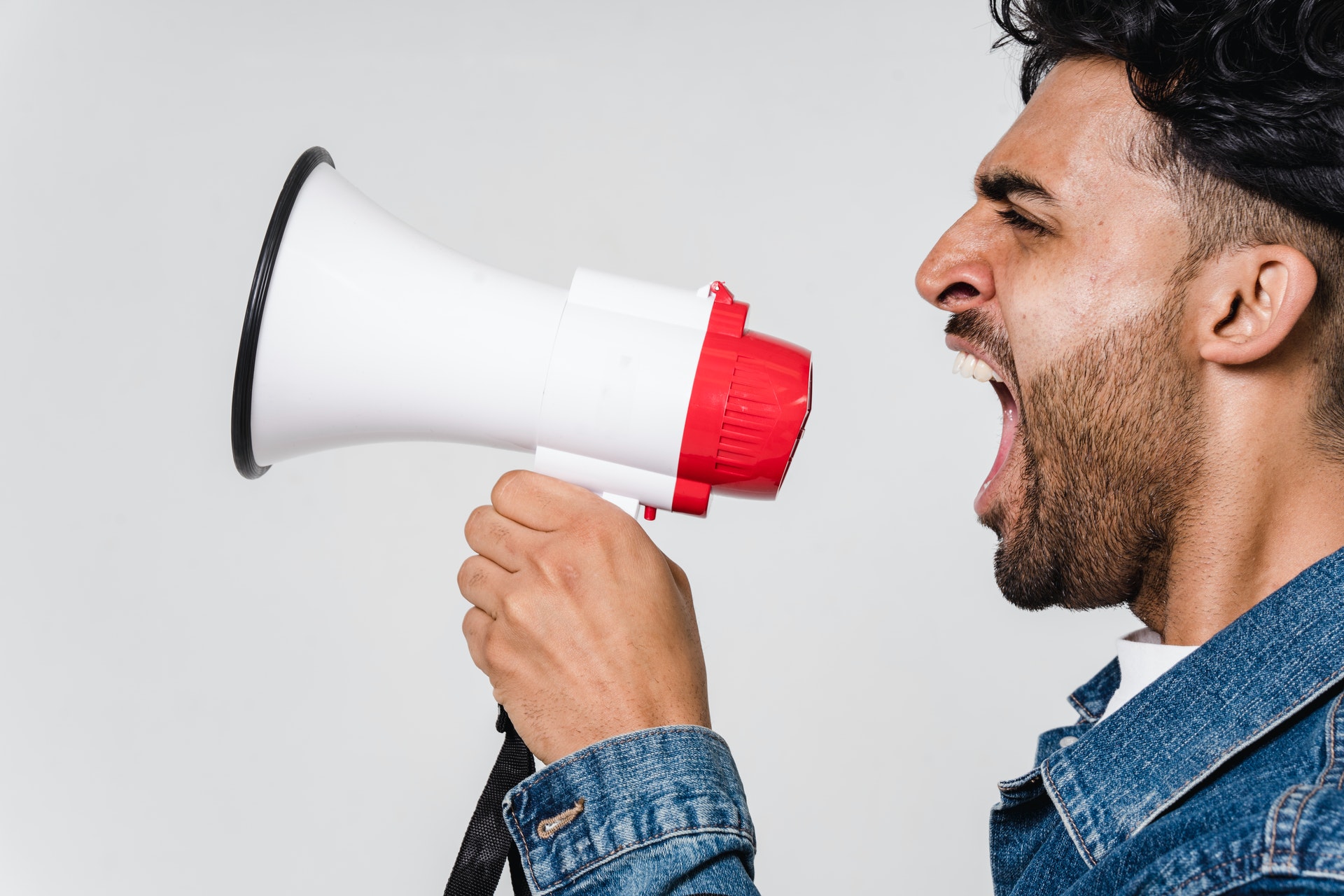an asian man speaking through a megaphone