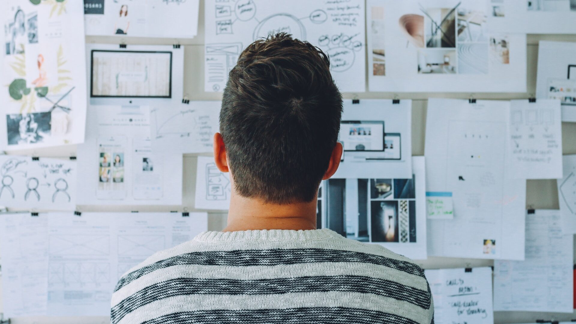 a man staring at a whiteboard