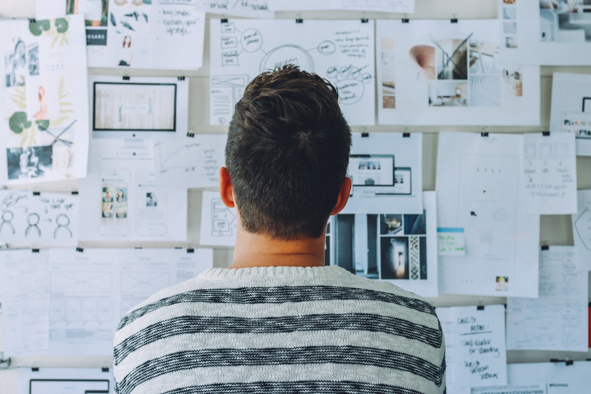a man staring at a whiteboard