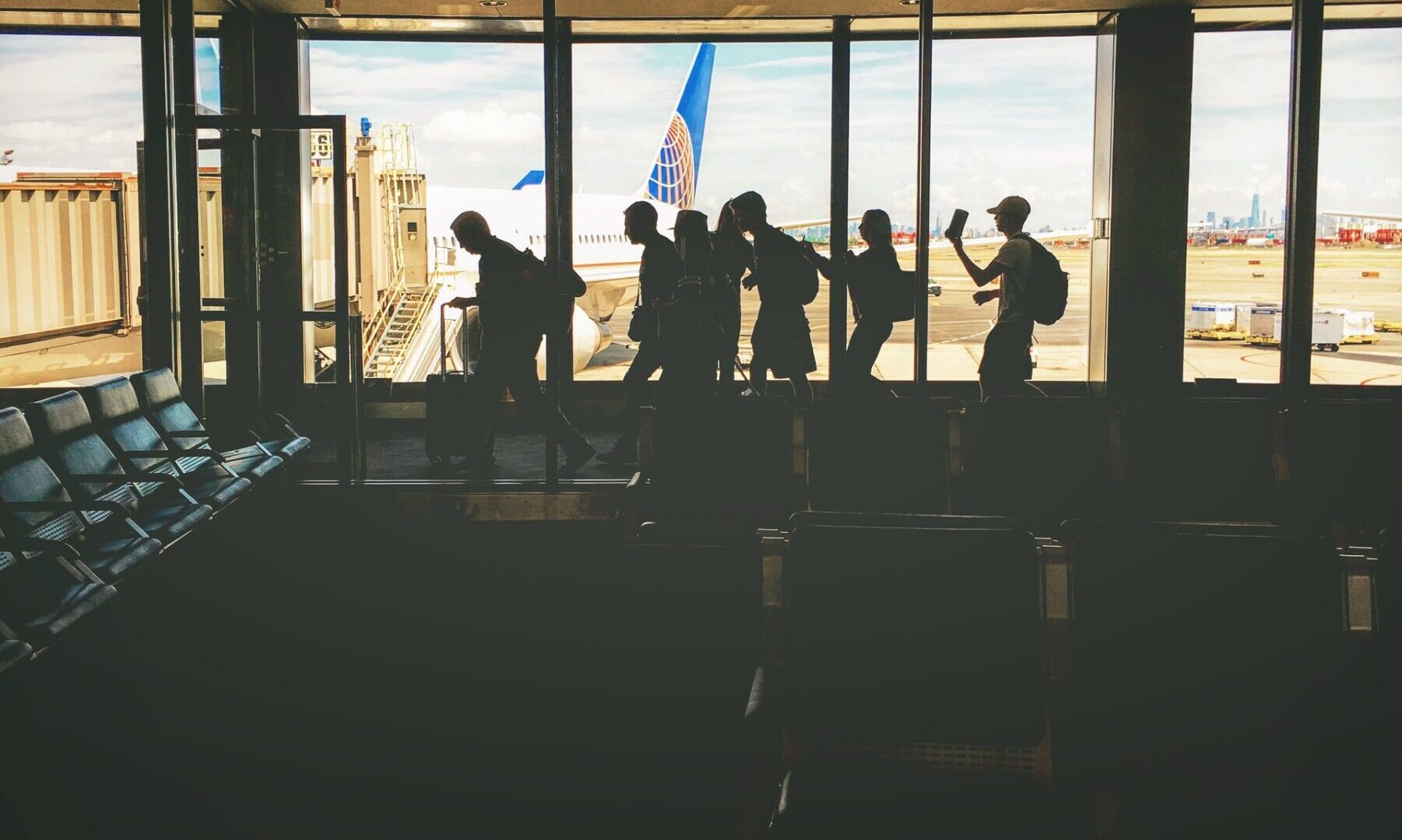 people waiting in line to board a plane