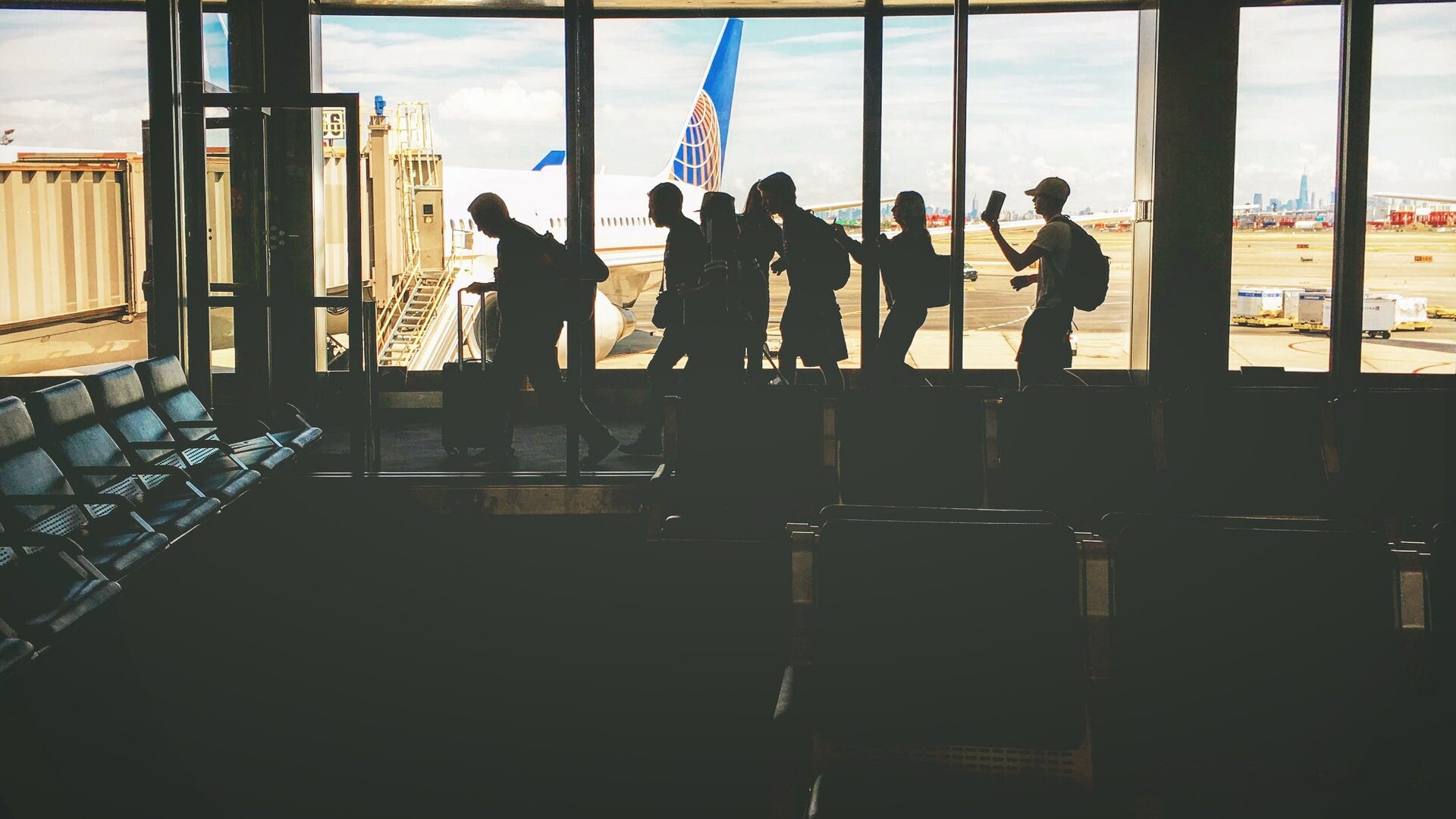 people waiting in line to board a plane