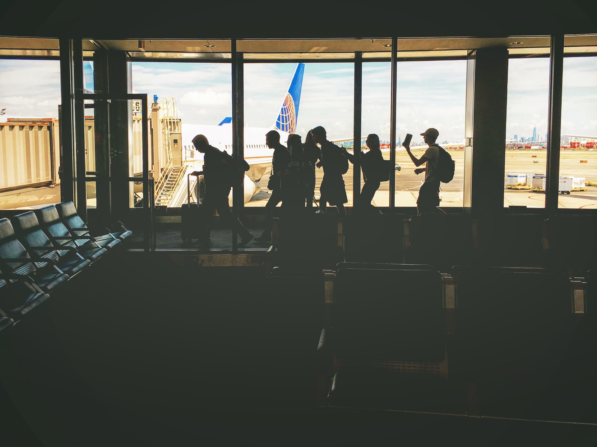 people waiting in line to board a plane