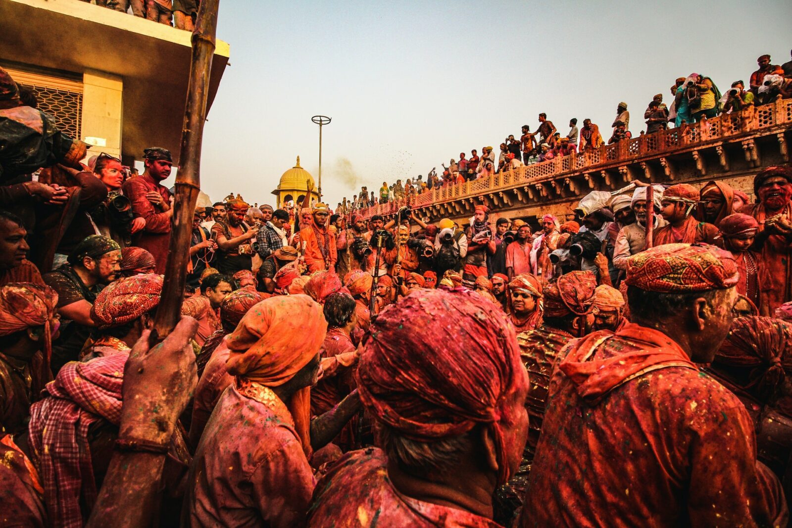 Festival of colors - Man Standing Infront of Brown Concrete Bridge