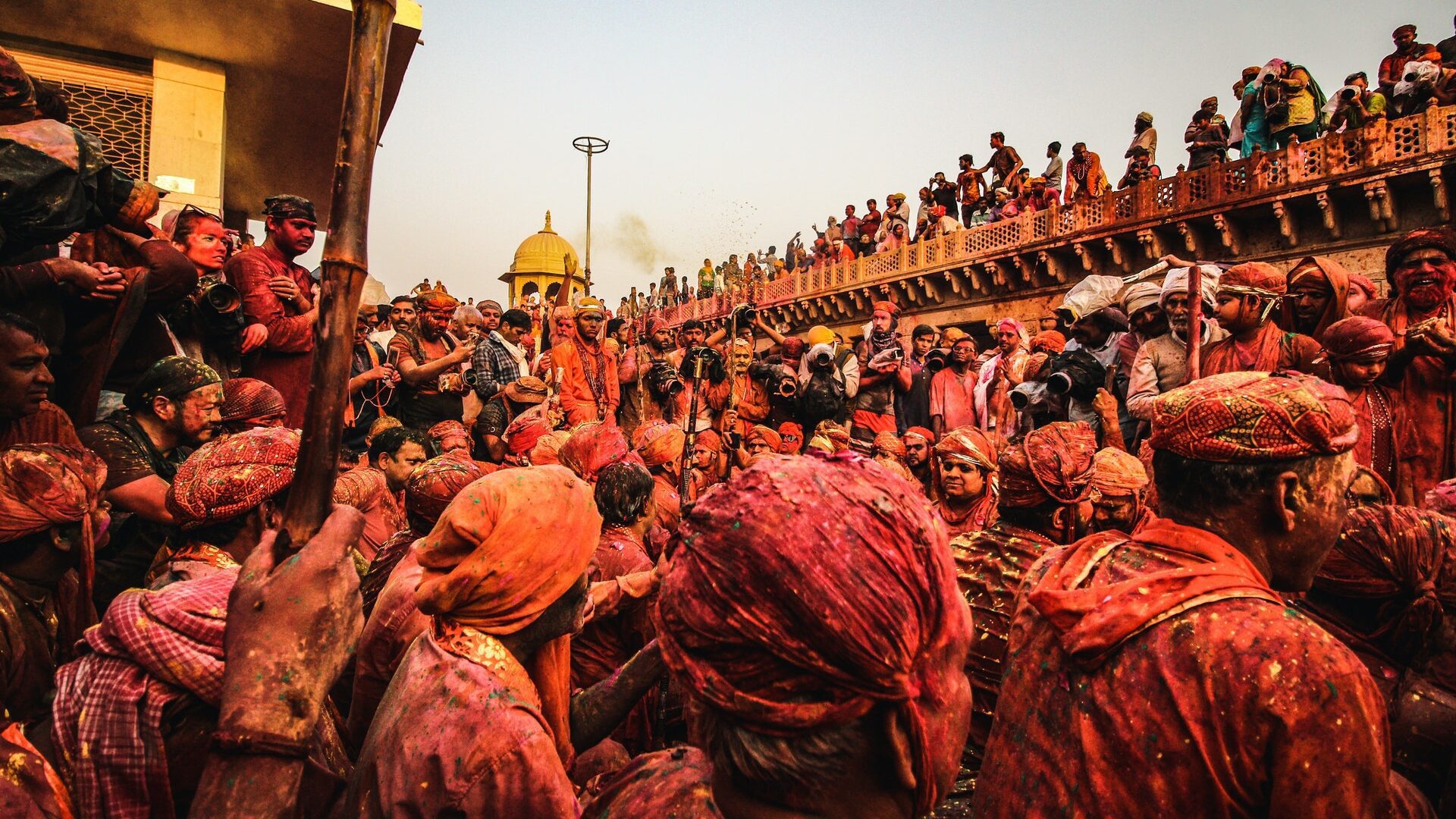 Festival of colors - Man Standing Infront of Brown Concrete Bridge