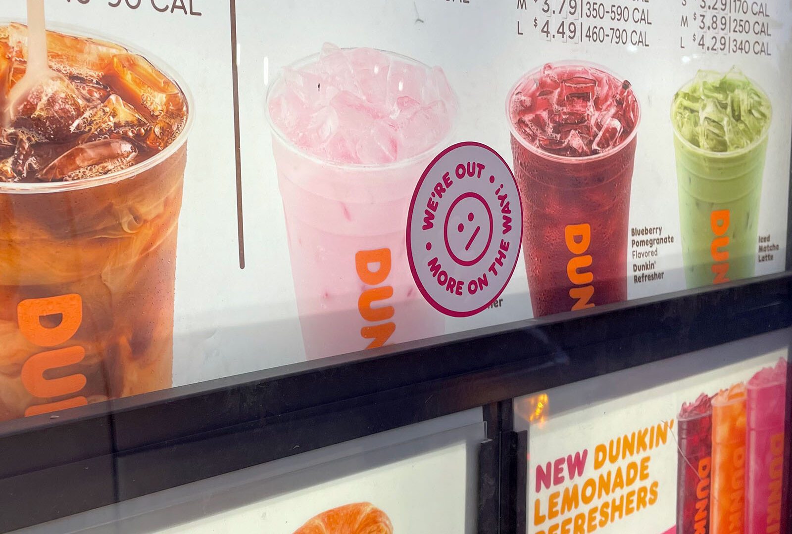 a menuboard with a sticker on it that tells people the item is not being offered