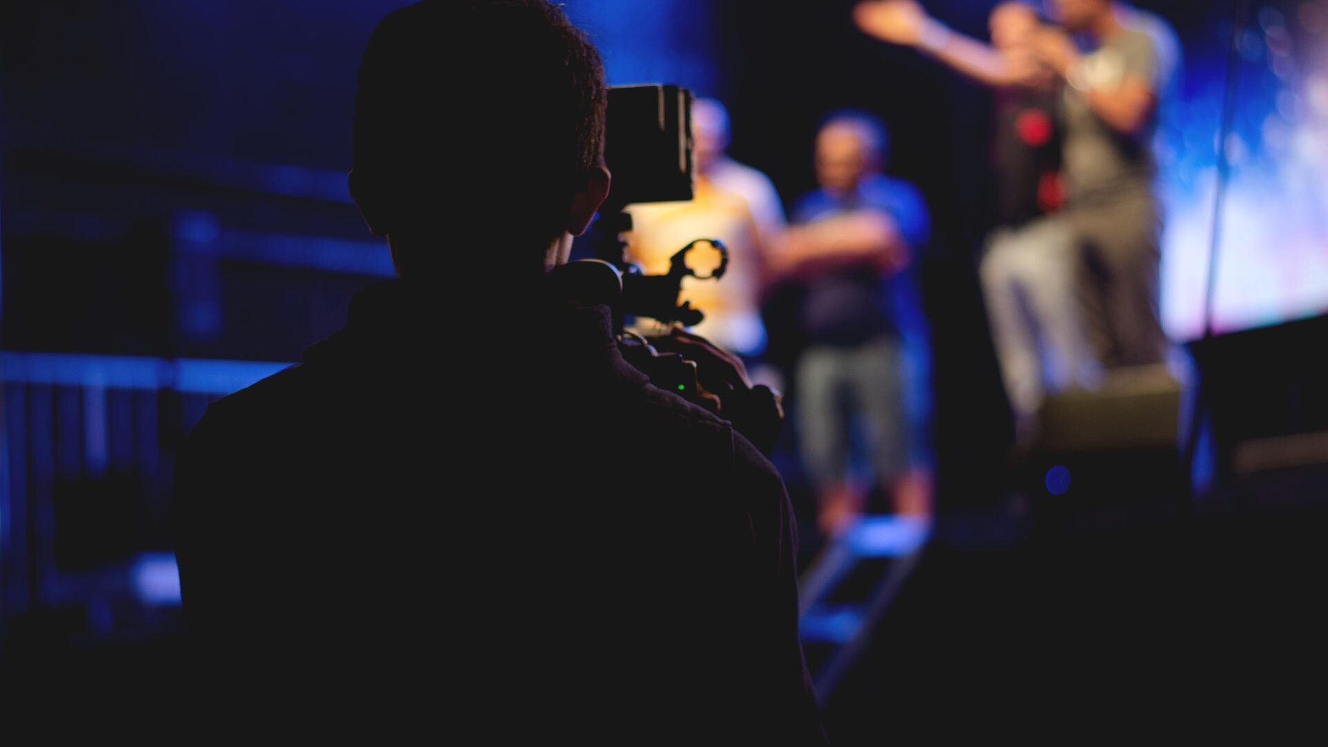 a person shooting video of actors