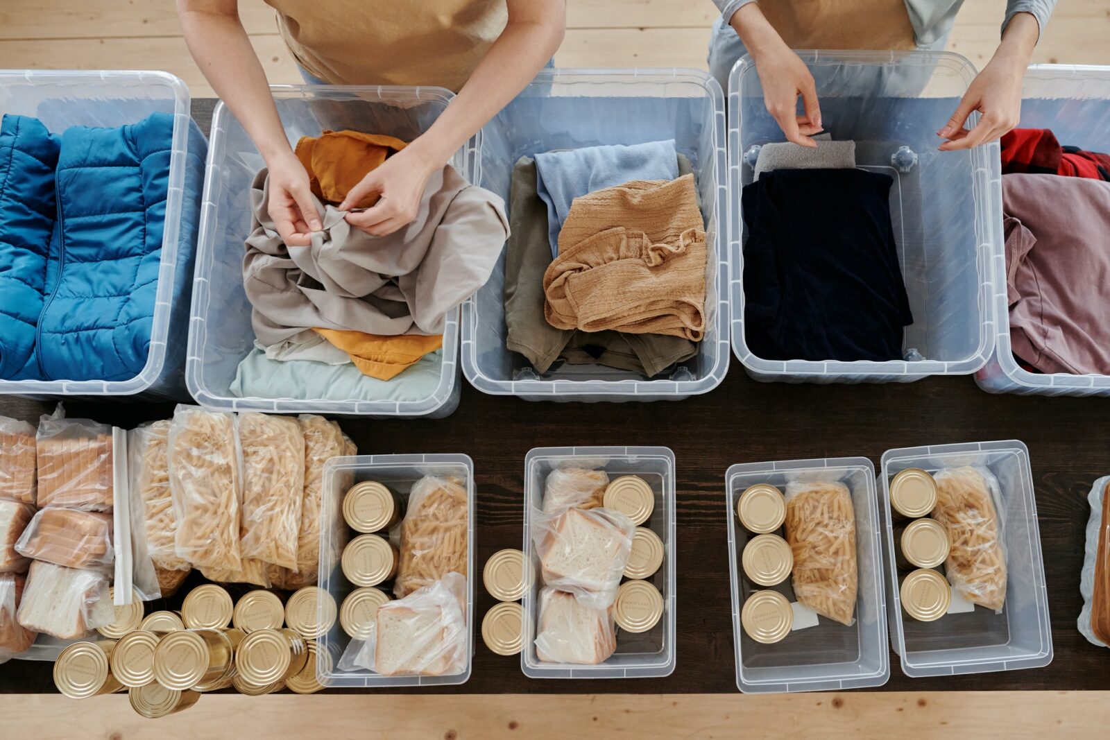 two people sorting items in bins