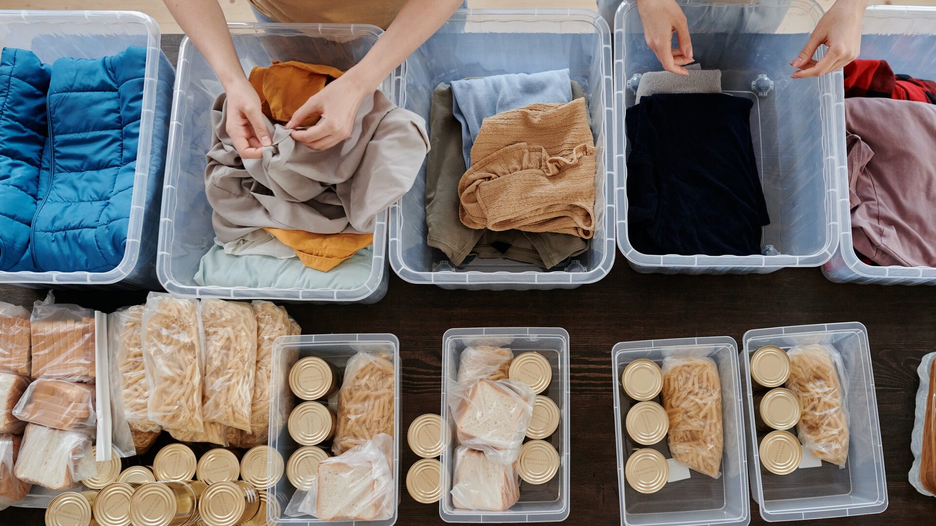 two people sorting items in bins