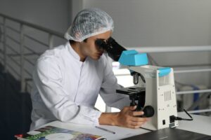 a man looking through a microscope