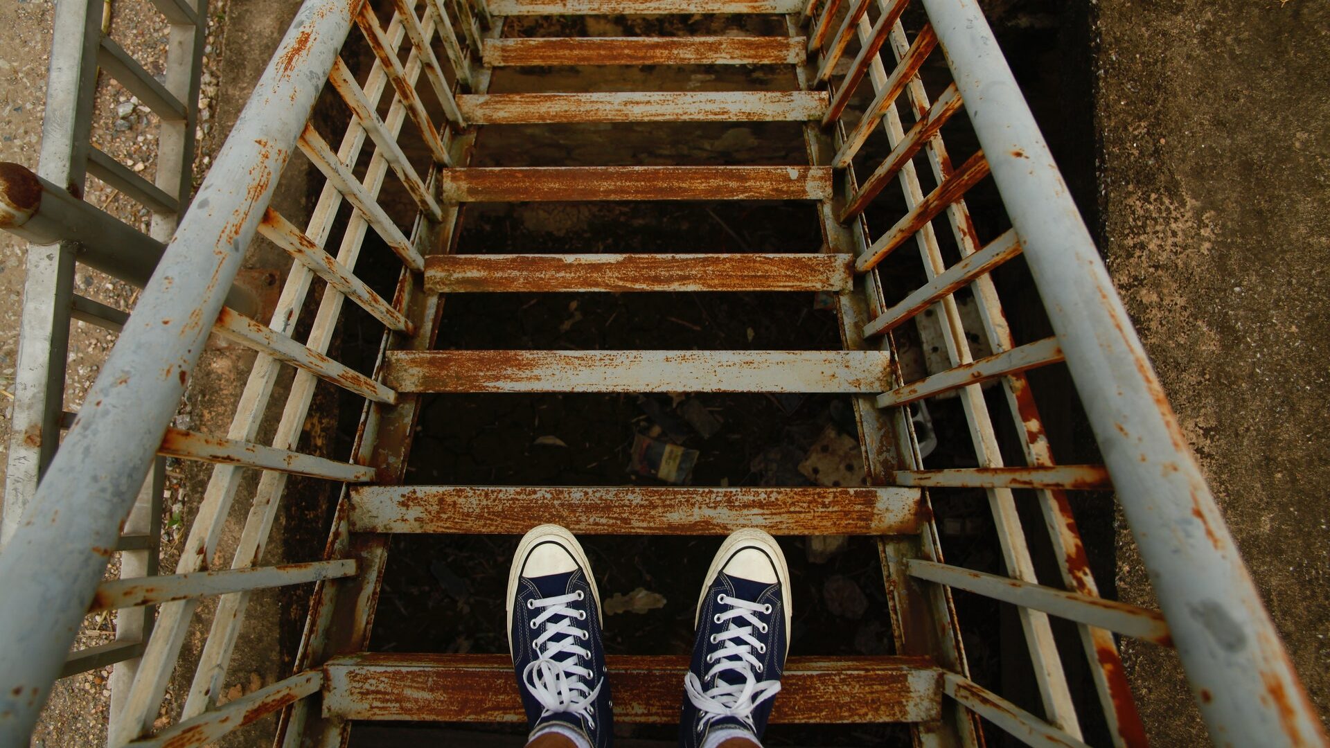 man standing on stairs looking down the steps