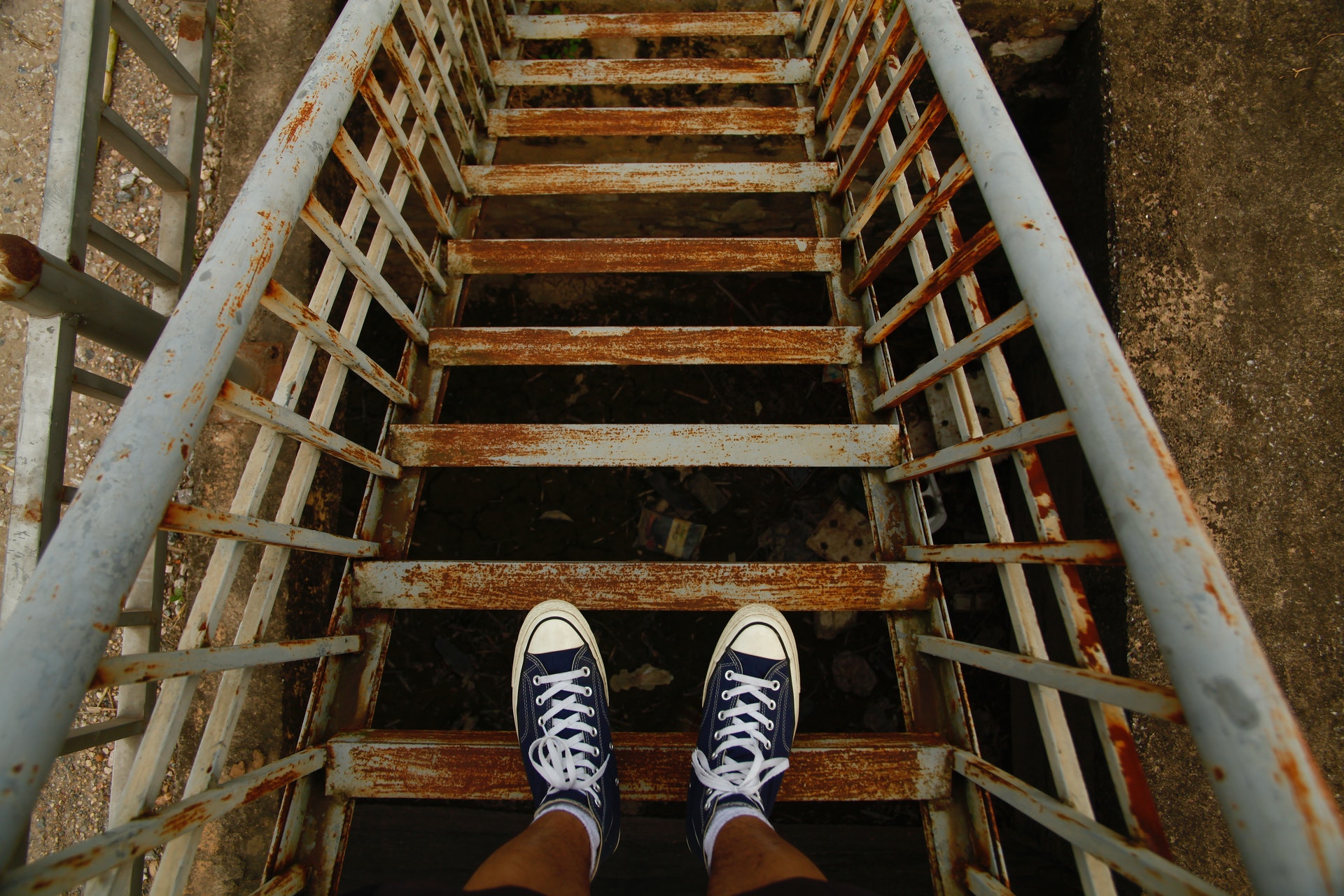 man standing on stairs looking down the steps