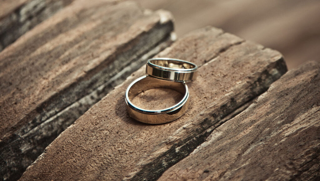 plain wedding ring bands sitting on a bench