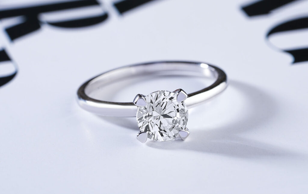 a diamond engagement ring sitting on a table