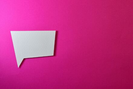 paper background with a speech bubble cut out in paoer